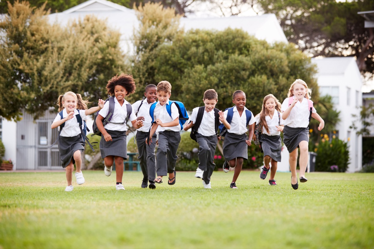 Students running together across the schoolyard